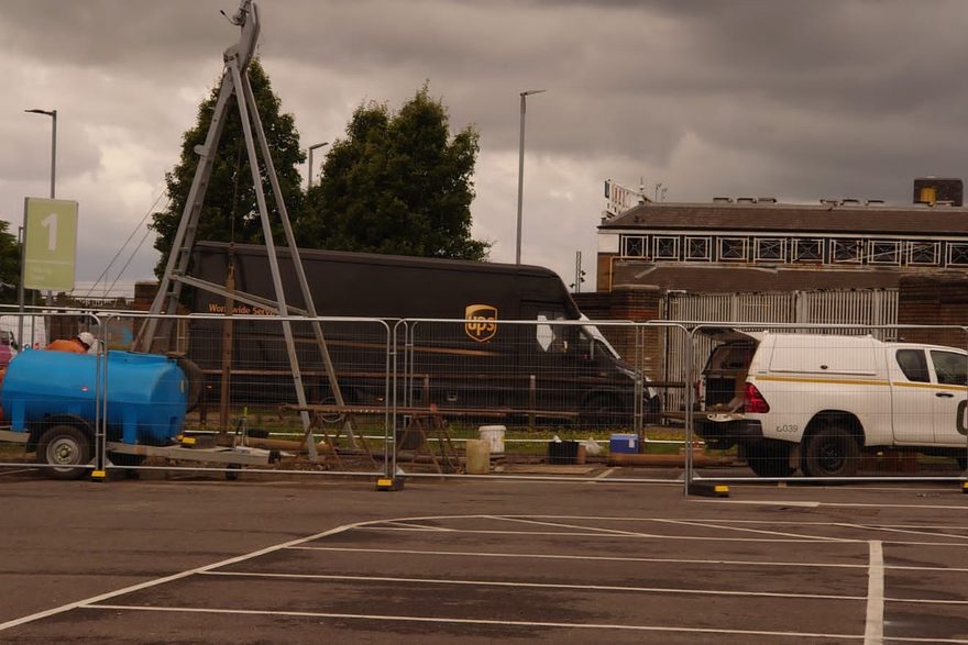 Dando cable percussion rig set up in a fenced compound