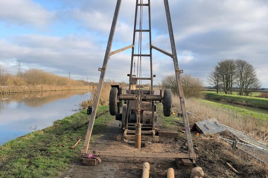 Geotron Dando cable percussion rig mast on a canal-side borehole