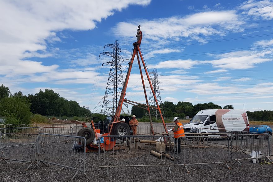 Geotron Dando cable percussion rig working beneath power lines