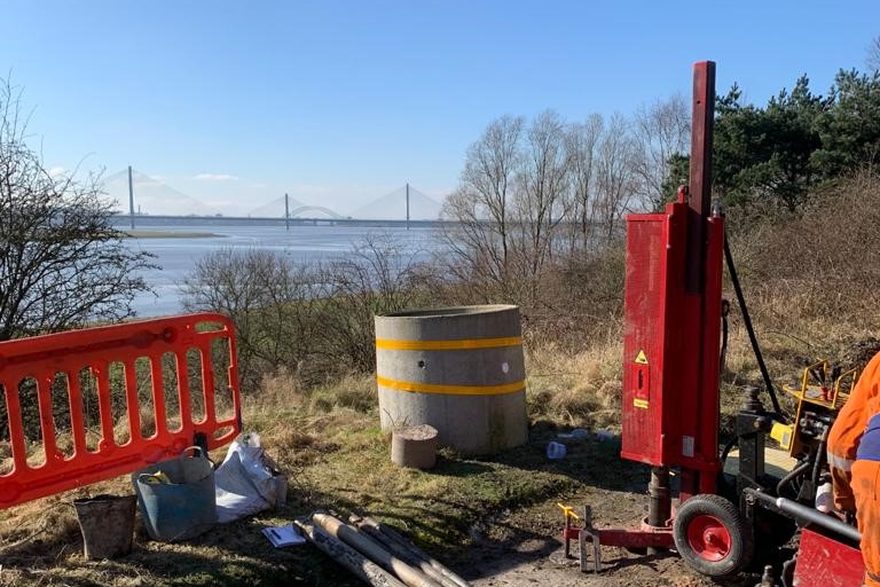 Tracked window sampling rig working a borehole beside a river